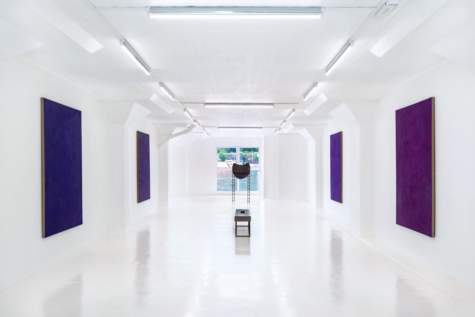 The gallery during Smoke Inside, 2018: four large purple canvases and a sculpture on a plinth, harbour in the window